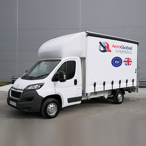 Express delivery Luton van from uk to europe standing in front of warehouse